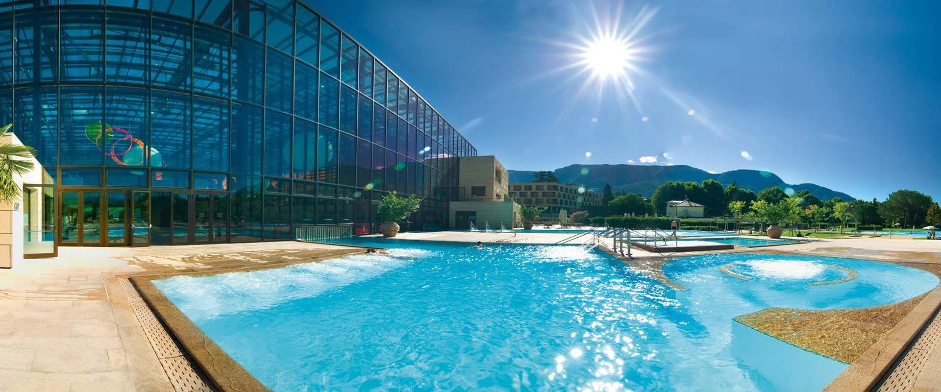 Outdoor swimming pool with sunbathing lawn.