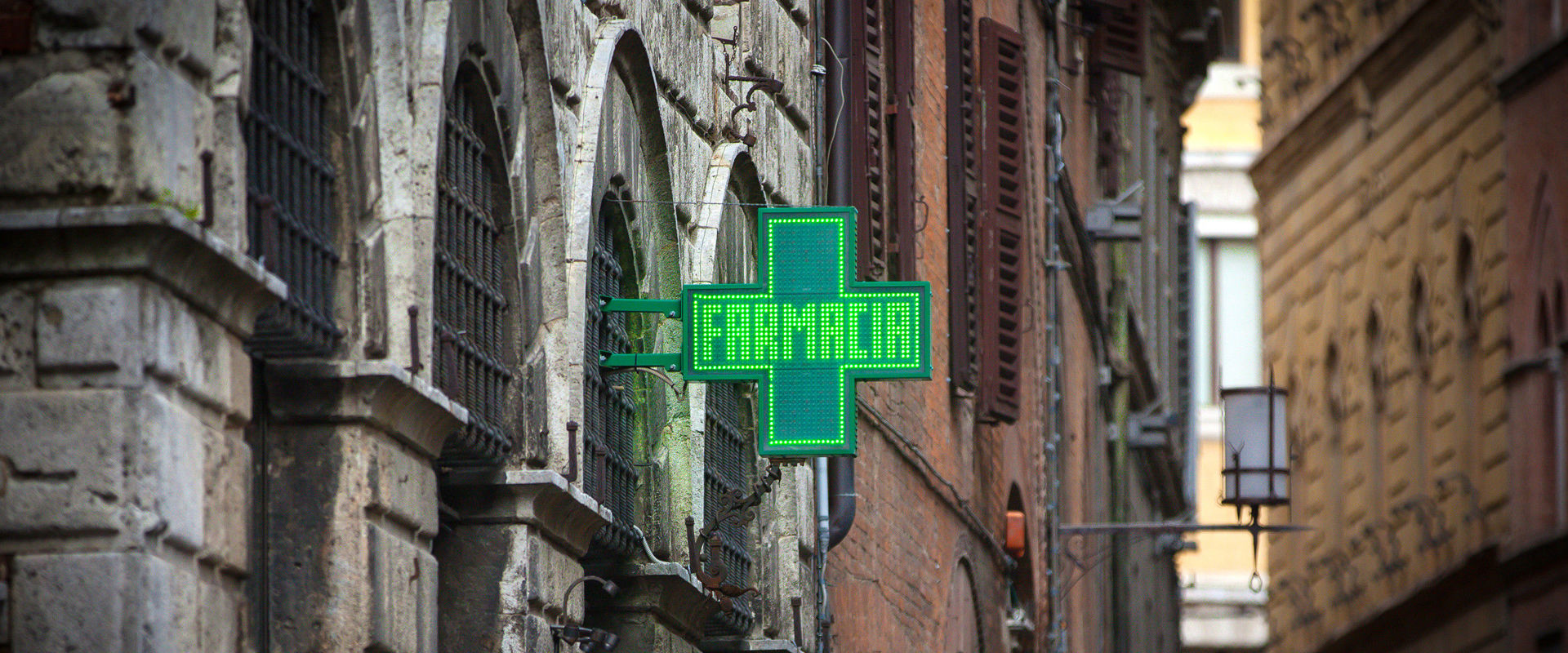 Pharmacy Green pharmacy sign hanging on the walls of a house.