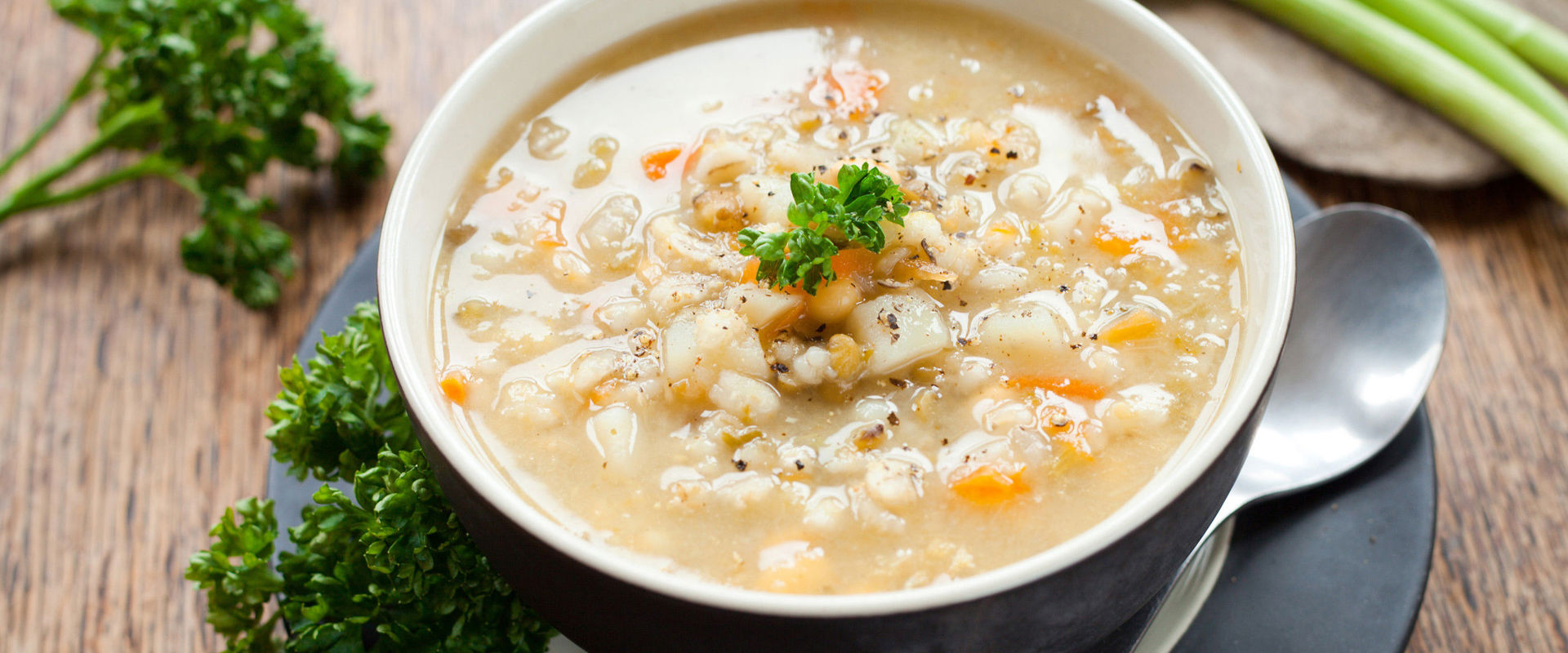 Gerstensuppe: barley soup Plate of barley soup decorated with vegetables.