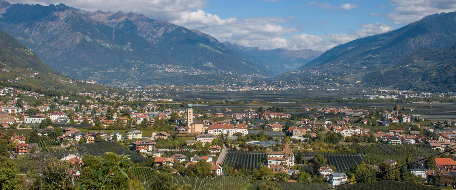 Lana near Meran. View of the houses, green vineyards and orchards of Lana