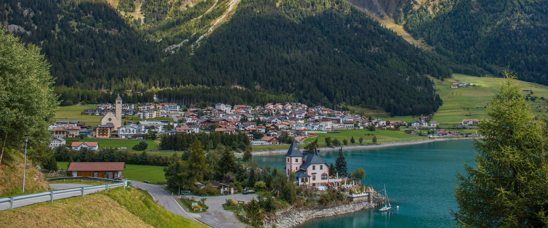 Reschen in Vinschgau View of the northern shore of Lake Reschen, with the village of Reschen in the background