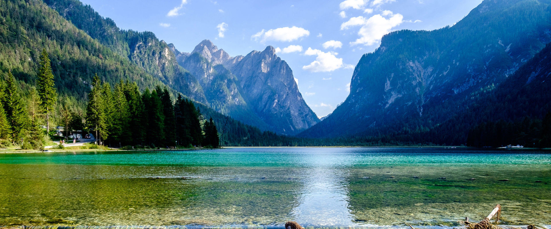 Lake Toblach. Water step of turquise green lake framed by mountains.