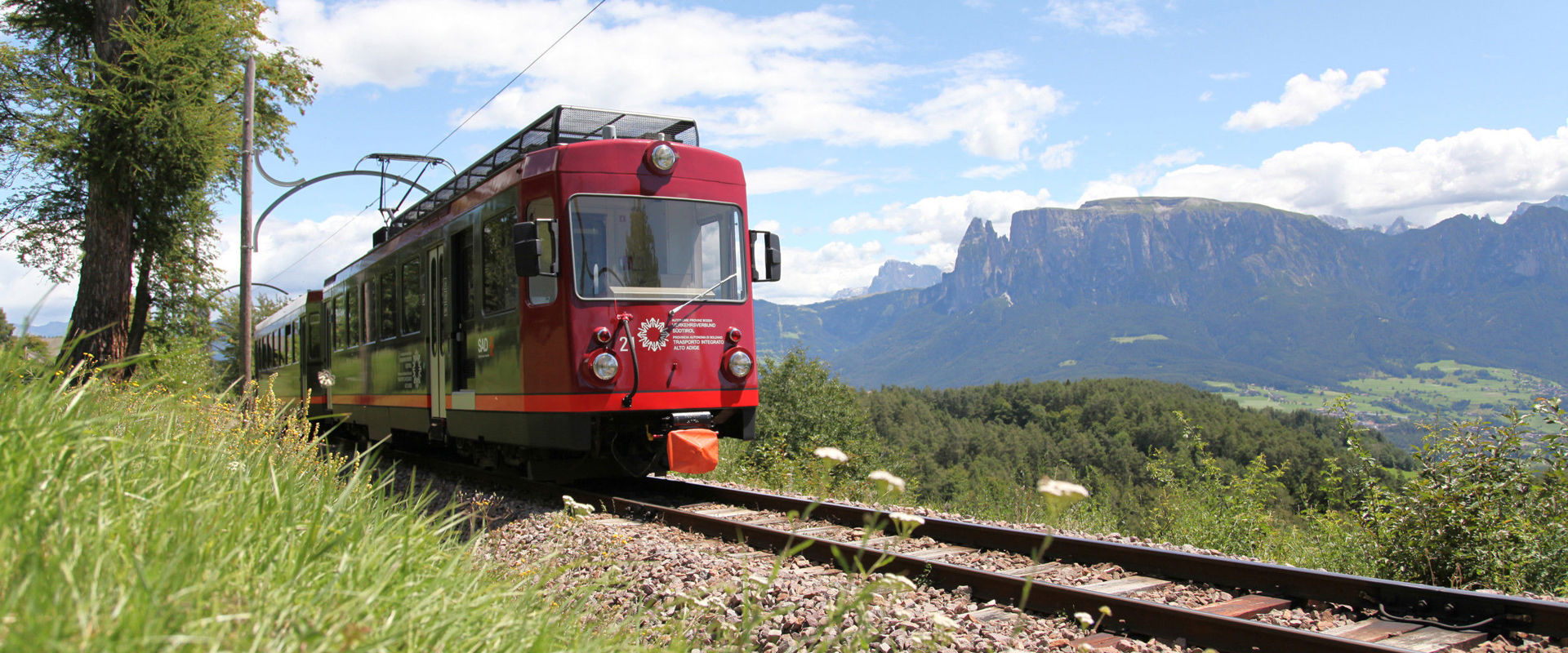 Rittner Railway Red railway surrounded by a beautiful natural landscape.