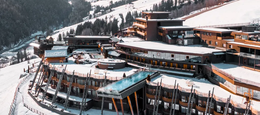 View of the Hotel Hubertus terrace with sky pool and breathtaking views of the mountains.