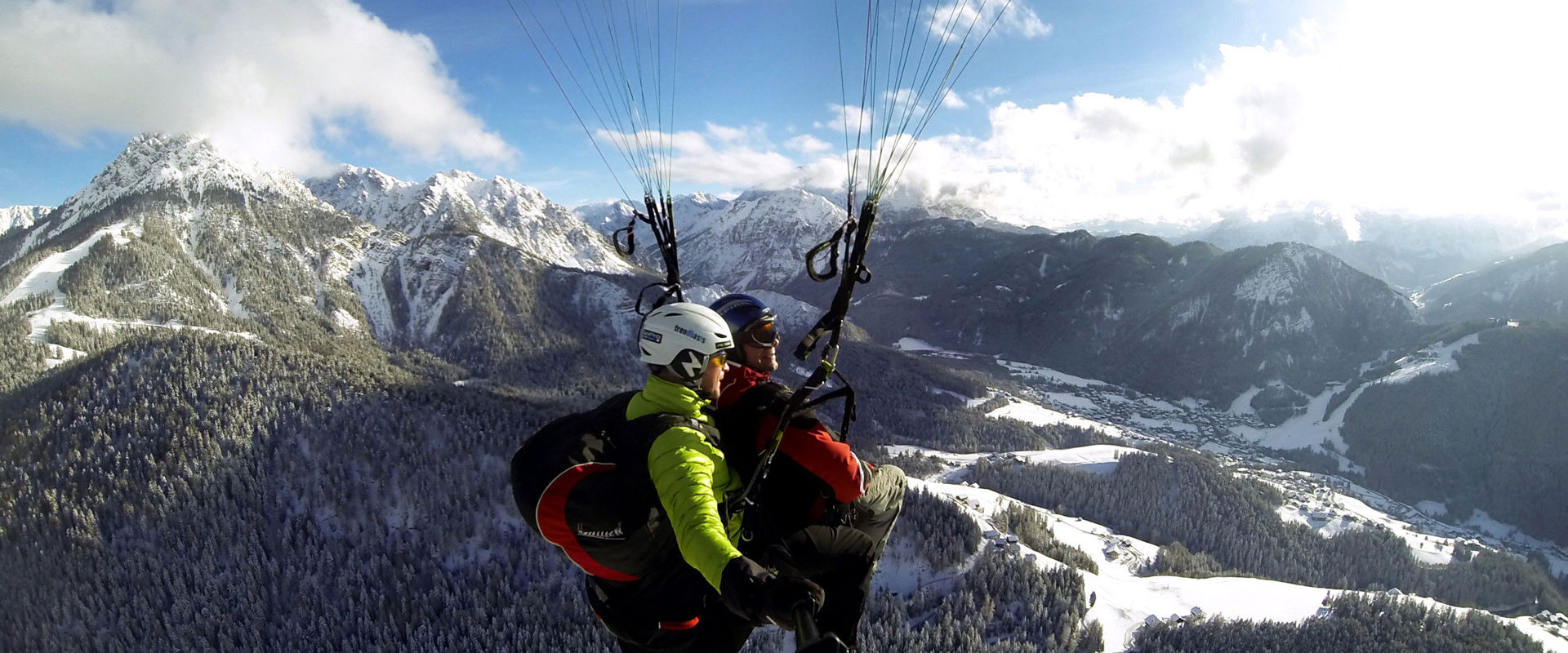 Tandem paragliding over mount Kronplatz Plan in winter.