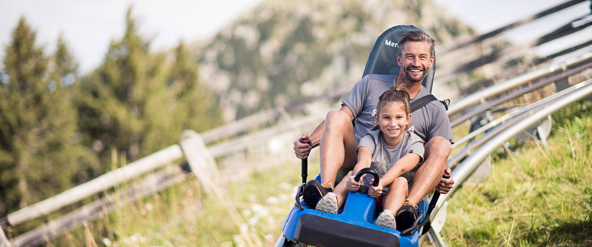 Alpin Bob a Meran 2000 Father and daughter descend happily from the Alpine Bob at Meran 2000.