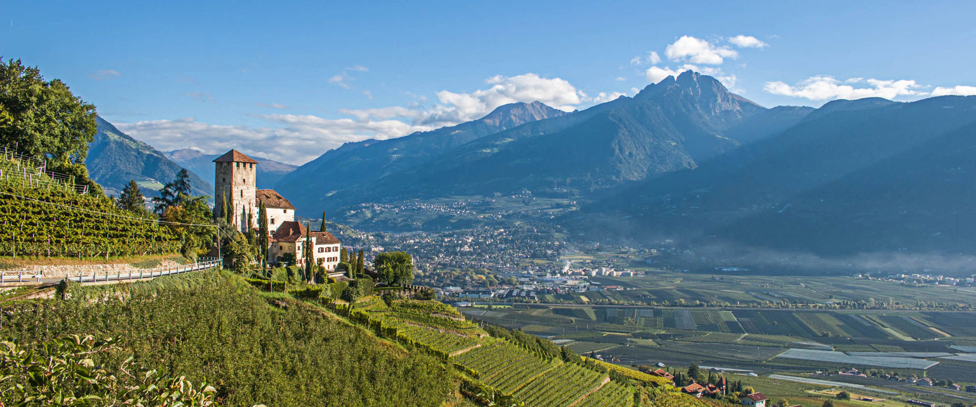 Lebenberg Castle surrounded by vineyards and apple orchards.