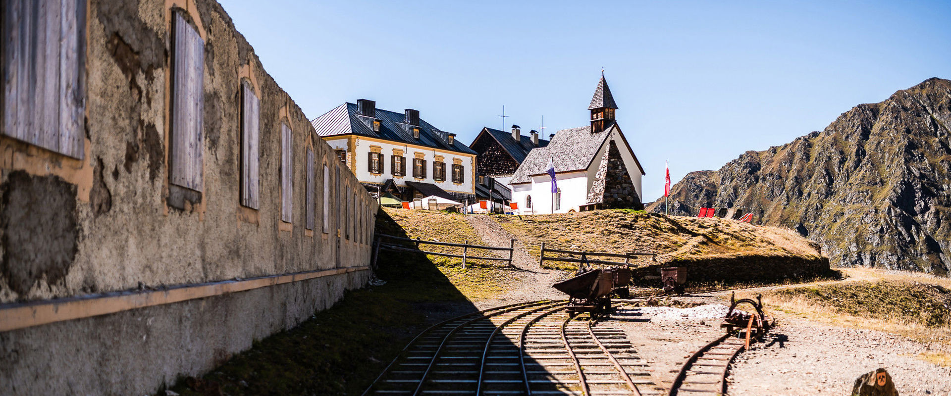Schneeberg Adventure Mine View of the mine rails, a small church and the miners' village.