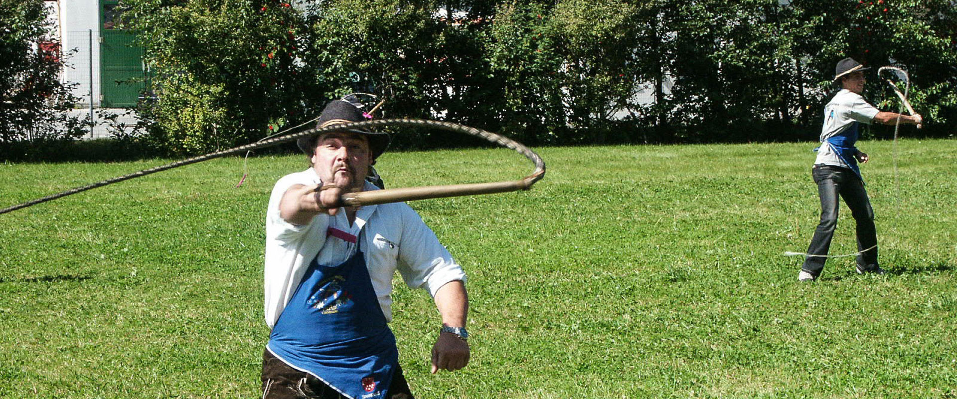 Goaslschnöllen Man in traditional clothings with a whip.