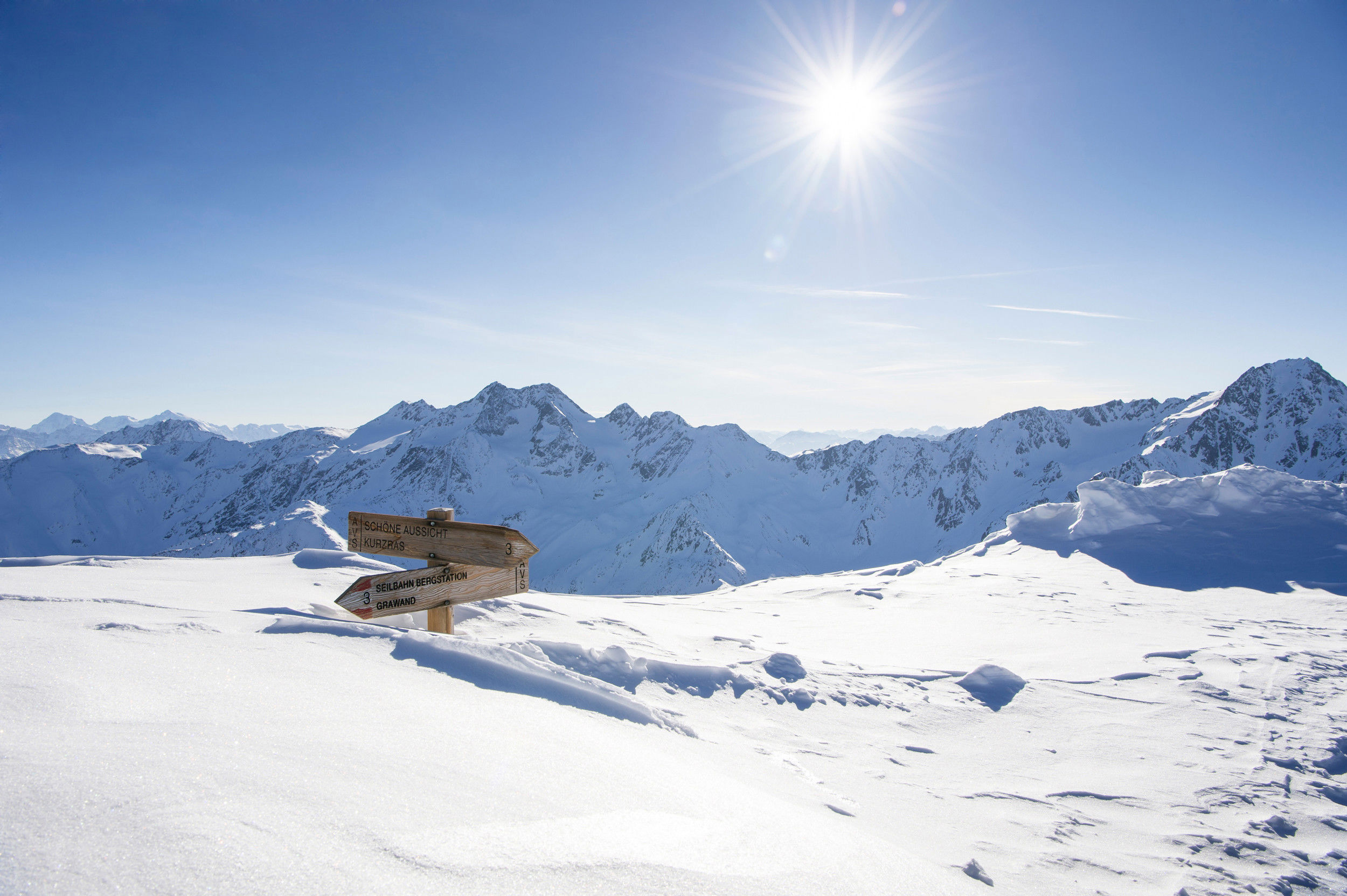 2 signposts are almost completely covered with snow.