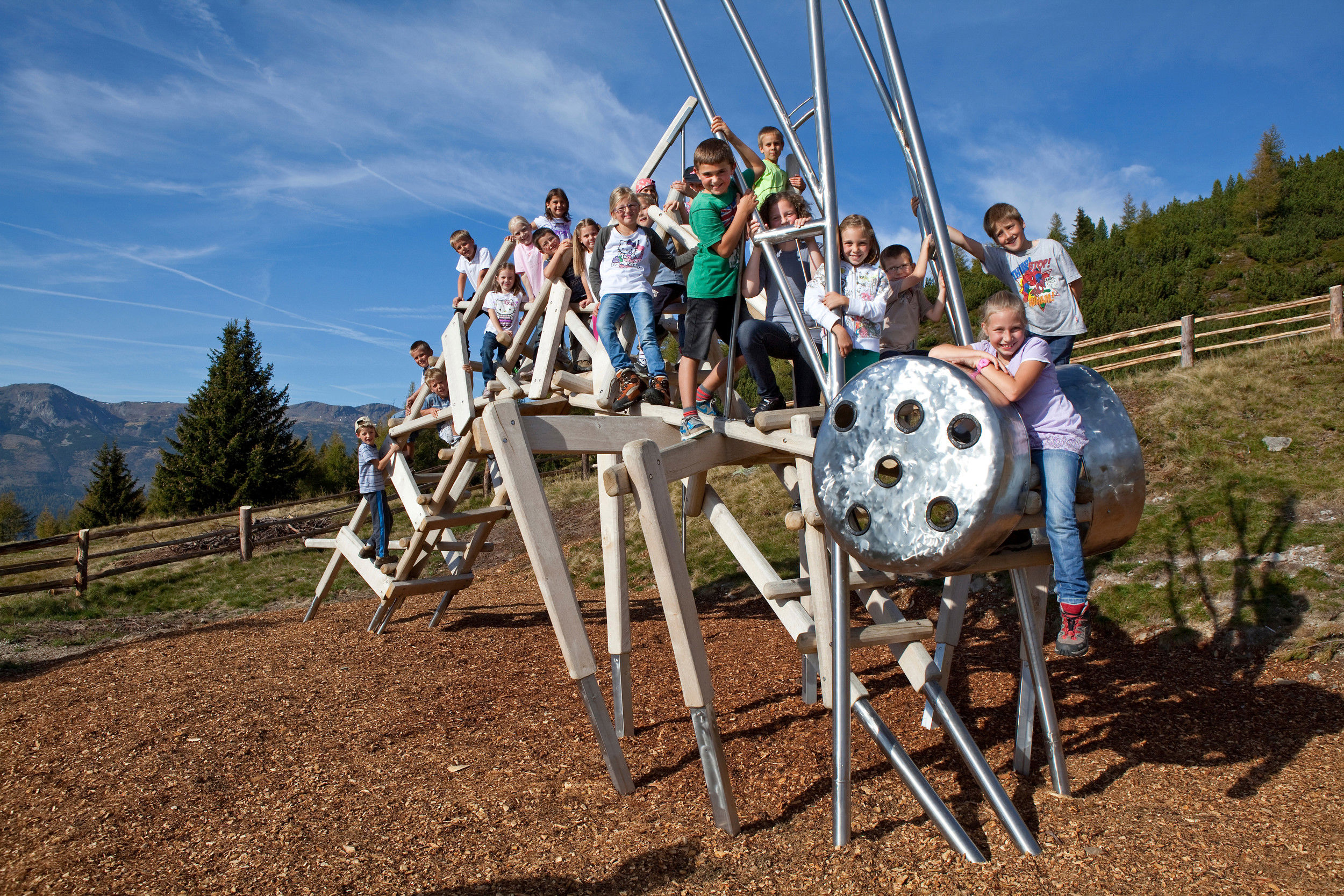 Children on a wooden animal scaffold.