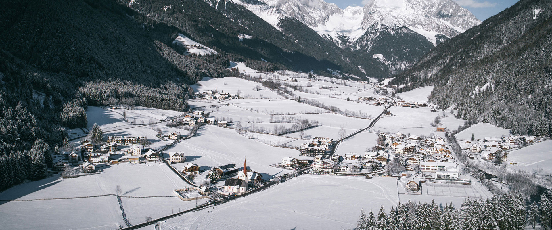 Antholz View over Antholz from above with snowcovered mountain landscape