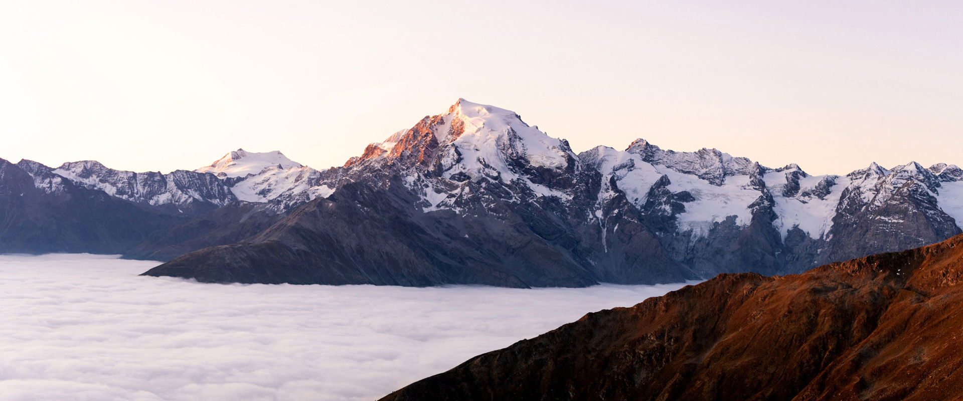Ortler  Snow-covered mountain peak of the Ortler. A sea of clouds spreads out below the summit.