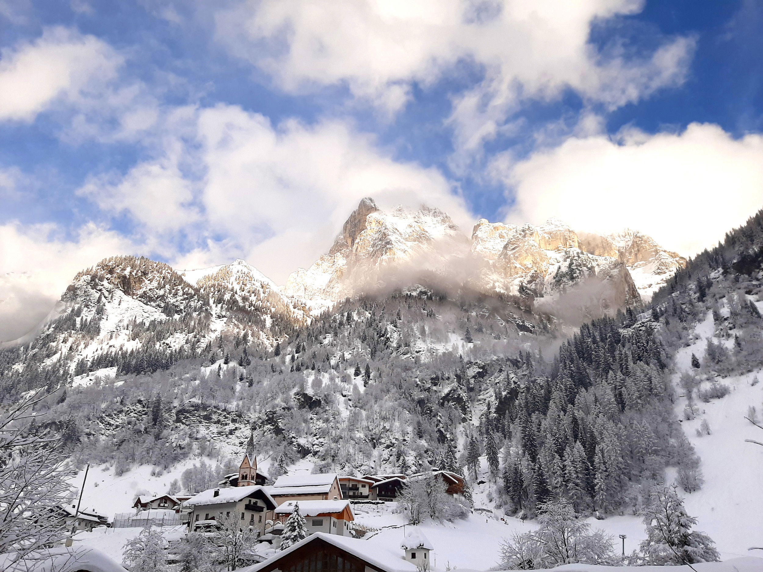 Pflersch with church in winter & snowcovered mountain landscape