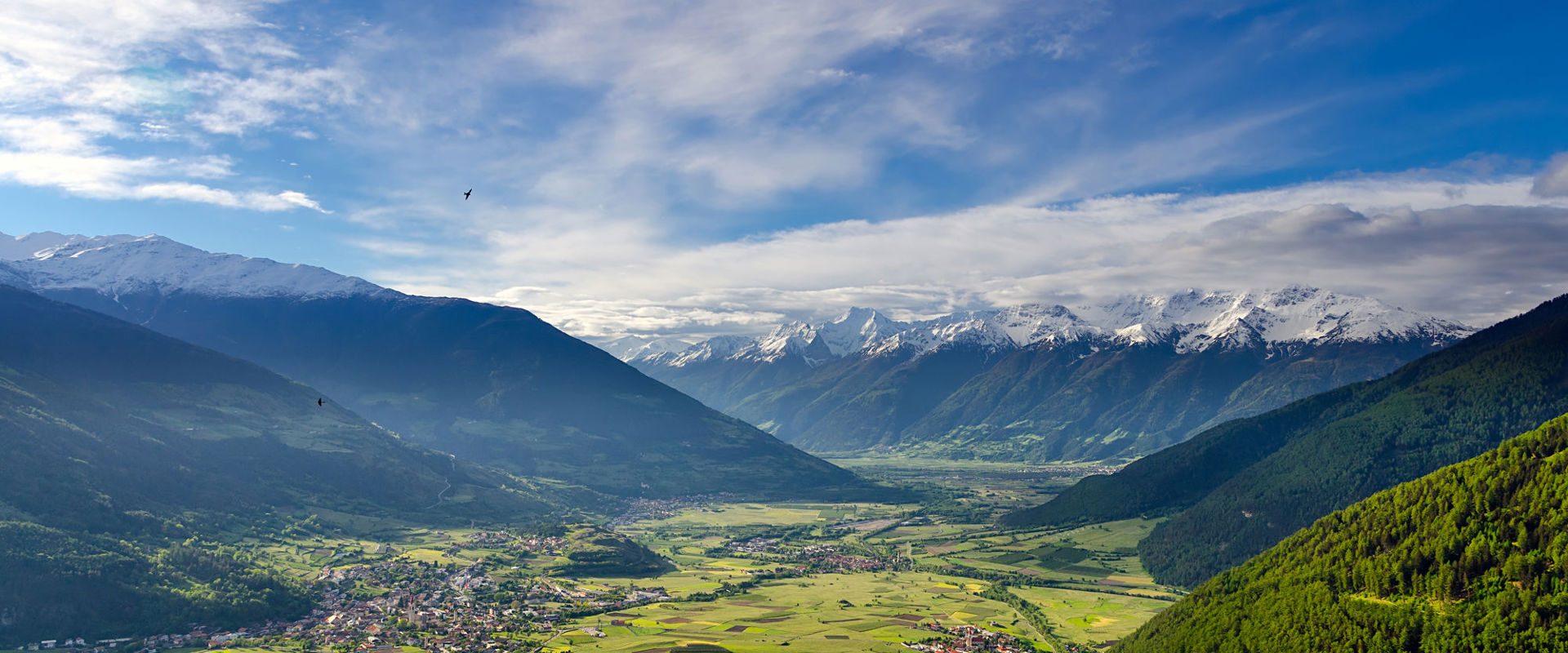 View of the mountain-lined central Vinschgau valley with Mals and Glurns seen from afar.