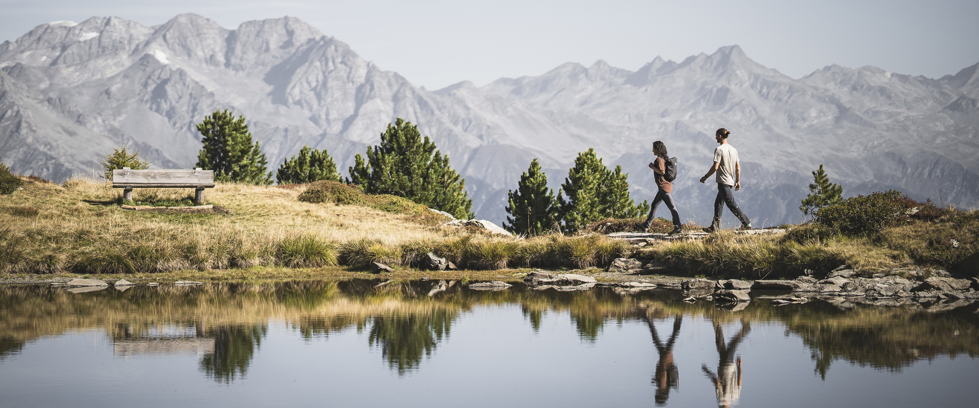 Two hikers  at the small lake Sonnklarsee on Speikboden