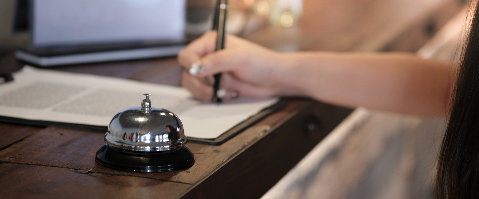 Local tax Bell and person signing at hotel reception