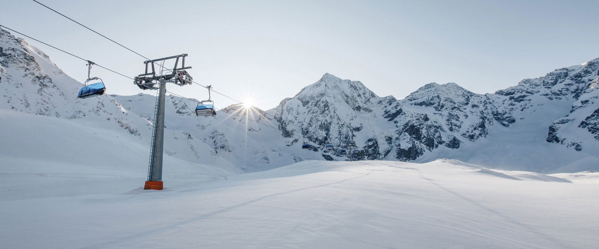 Skiing area Sulden Chairlift with freshly snow-covered mountain landscape.
