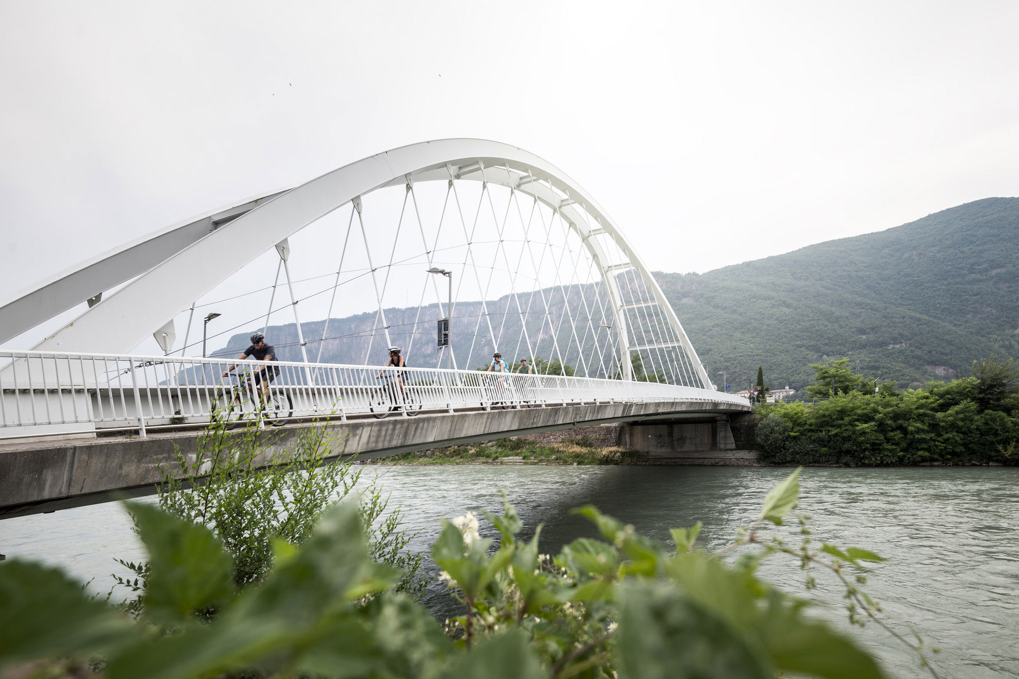 White bridge with cyclists