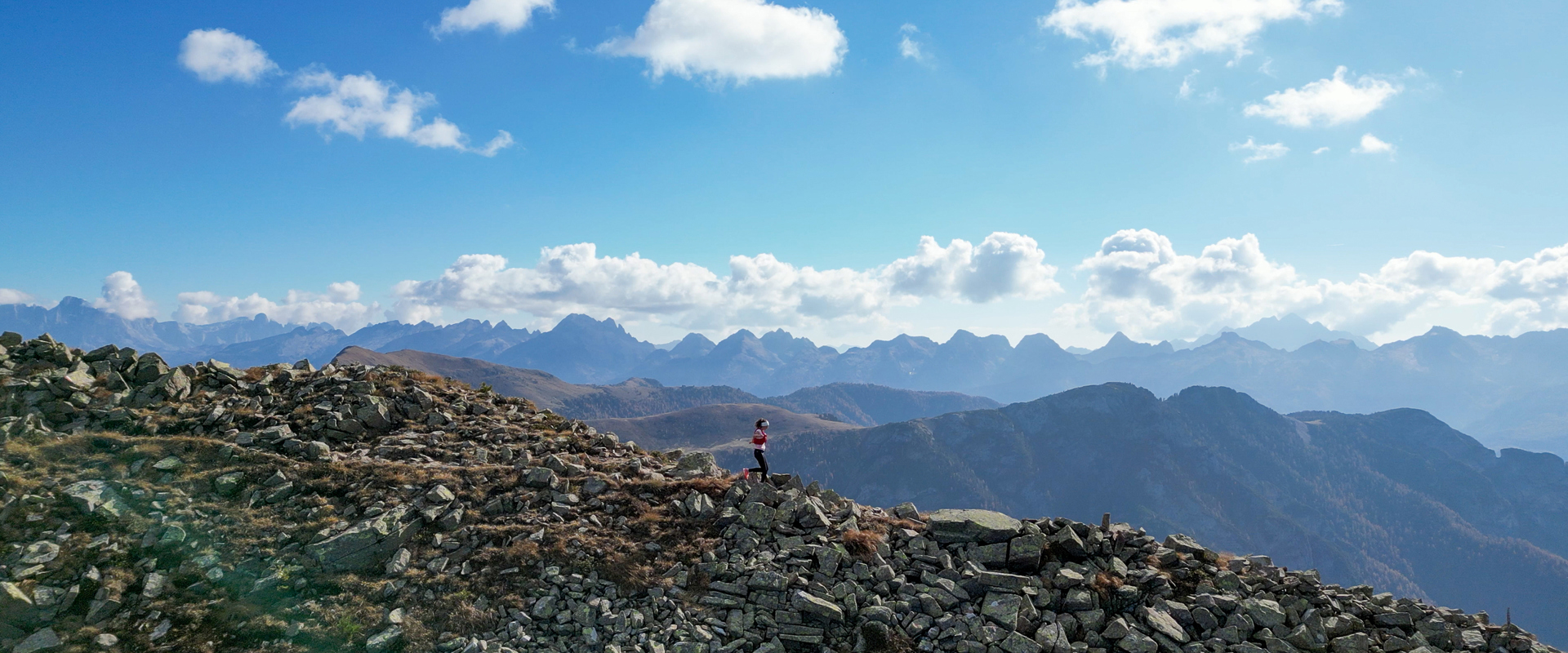 A girl runs along a path in the mountains