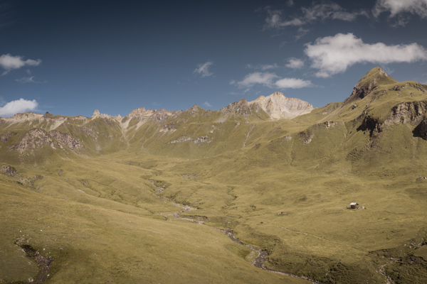 Gentle mountain meadows, huts and mountain peaks 