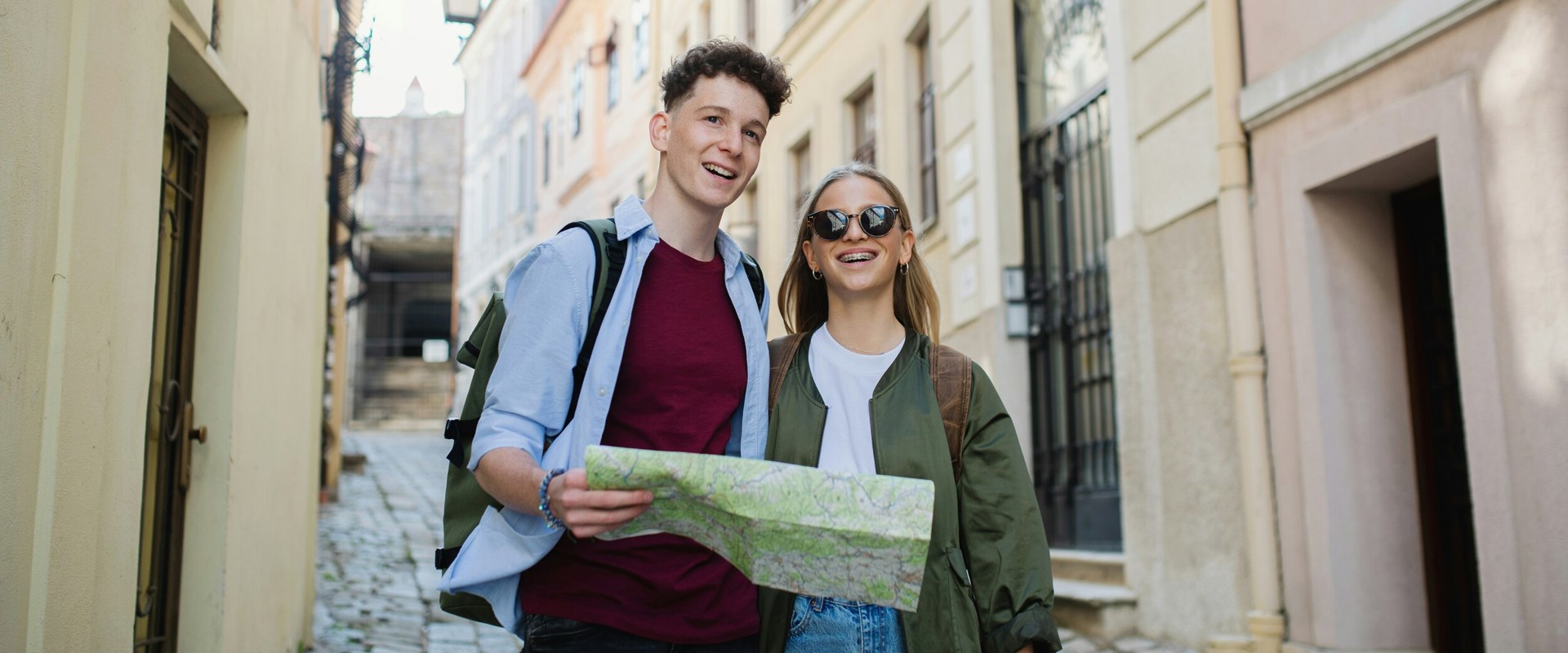 City maps Young couple on foot with map in city centre